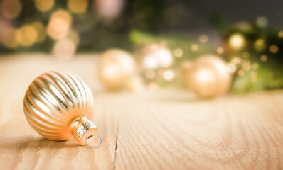 golden christmas ornaments on wood table
