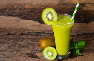 Kiwi yogurt fruit juice smoothie green colorful fruit juice milkshake blend beverage healthy high protein the taste yummy In glass drink episode morning on wood background.