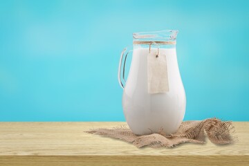 Glass and jug of fresh tasty milk, dairy products