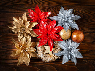 Christmas decorations. Top view New Year decorations on a dark wooden background. Vintage garlands, balls, stars and toys for Christmas decor. Festive postcard.