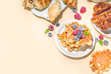 Modern dessert croffle - mixture of croissants and waffles, puff baking waffle iron pan, with berry, fruit cocolate topping