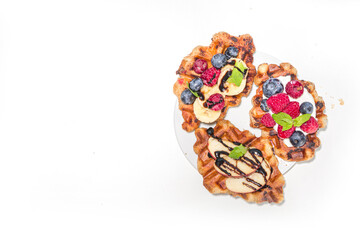 Modern dessert croffle - mixture of croissants and waffles, puff baking waffle iron pan, with berry, fruit cocolate topping