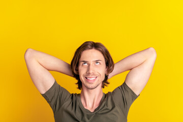 Top above high angle view photo of young guy happy positive smile dream look empty space rest isolated over yellow color background