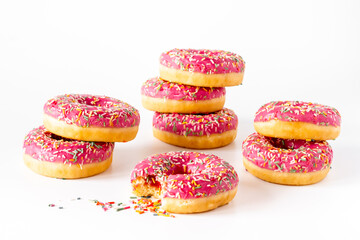 Close up of pink frosted donuts with colorful sprinkles