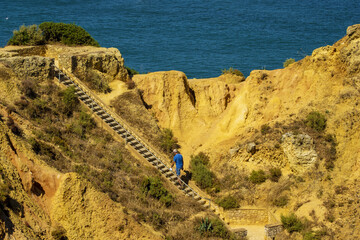 Fototapeta na wymiar Panoramic view with Cliff, rocks and tourist boat on sea at Ponta da Piedade near Lagos, Algarve, Portugal