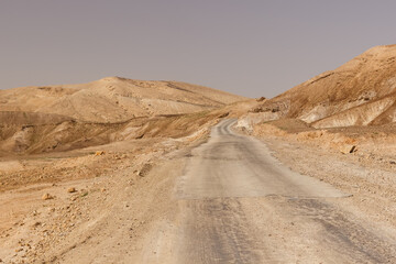 Road through hills and cliffs in the Judean Desert in Israel
