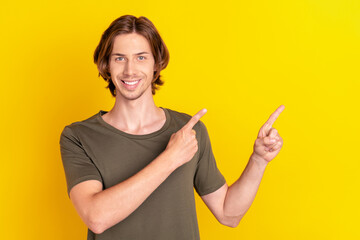 Photo of young guy happy positive smile point fingers empty space advertise follow recommend isolated over yellow color background