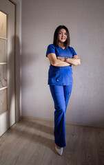 Fototapeta na wymiar Full portrait of happy female doctor standing in uniform