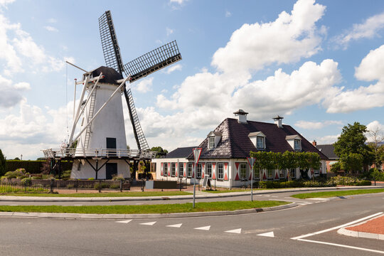 White flour mill at a crossroads of a provincial road in the Netherlands.
