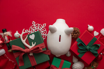 Festive Christmas financial savings concept. White piggy bank money box with presents and...