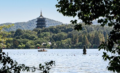 Beautiful landscape in the West Lake, Hangzhou, China, as a rowing boat passes the Leifeng Pagoda...