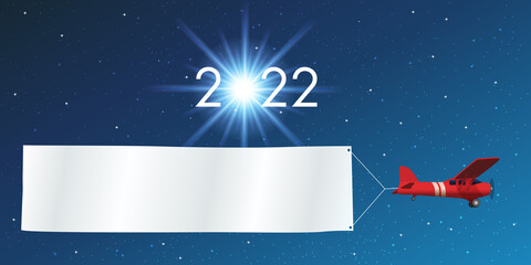 Carte de vœux 2022 montrant un avion rouge tirant une banderole blanche, devant un ciel étoilé. - obrazy, fototapety, plakaty