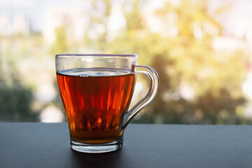 A cup of tea is at the window. Morning tea. Tea party on the background of the window