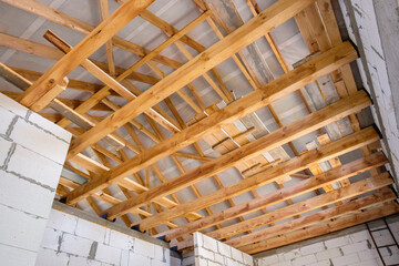 New construction of a wooden roof. Wood girder beams for new roof construction at construction site
