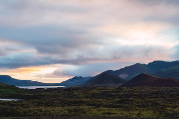 Mountains at sunset with green meadow