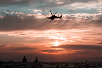 Fototapeta na wymiar helicopters in the sky over the gulf of Izmir sunset