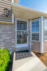 Entrance of a house with glass front door with grills