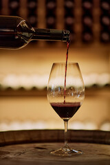 Pouring red wine into a glass