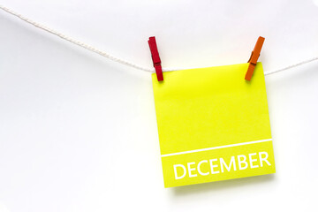 December. Month, Calendar month. Paper cards with calendar day hanging rope with clothespins on white background. Winter , month of the year concept.