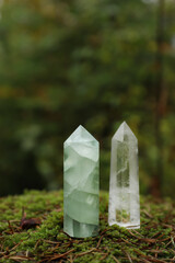 Different crystals on moss in forest, space for text