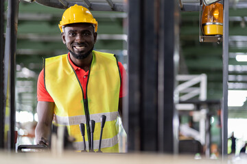 African American male worker driving on forklift truck for transfer products or parcel goods in the industrial storage warehouse. multicultural worker