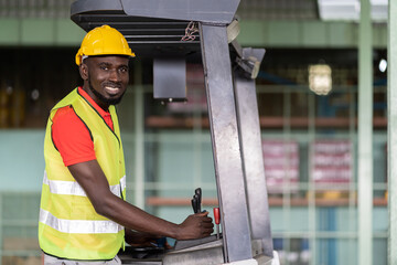 African American male worker driving on forklift truck for transfer products or parcel goods in the industrial storage warehouse. multicultural worker © amorn
