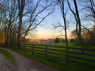 Rural Evening Scene in Autumn with Fences, Trees and Fields