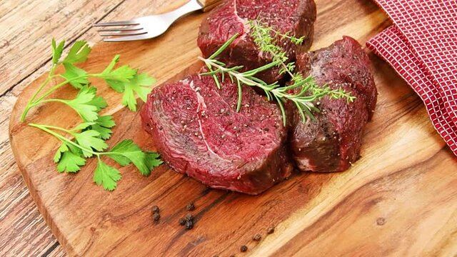 tournedos de boeuf cru sur une planche &agrave; d&eacute;couper