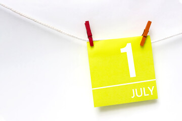 July 1st . Day 1 of month, Calendar date. Paper cards with calendar day hanging rope with clothespins on white background. Summer month, day of the year concept.