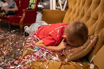 Introverted boy with autism disorder hide his face in pillow and plug ears with fingers at a noisy...