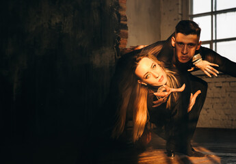 Portrait of Couple two professional ballroom dancers in loft studio. Sport life concept. Passion and emotional dance.