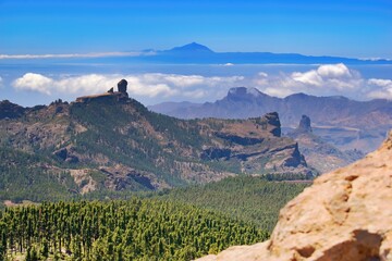 Panoramic view over Gran Canaria Island. Famous rock Roque Nublo and island Tenerife with highest peak Pico del Teide. - obrazy, fototapety, plakaty