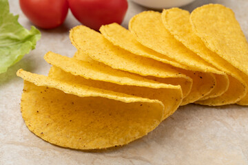 Empty mexican taco shells close up on a stone background ready to fill  