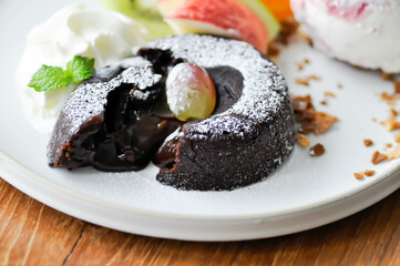 chocolate cake or chocolate lava cake with ice cream and fruit