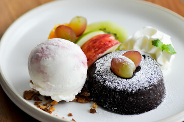chocolate cake or chocolate lava cake with ice cream and fruit