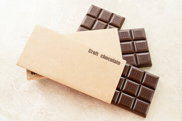 Handmade chocolate. Black bitter craft chocolate on white background. Healthy food concept, delicious chocolate sweets, diet, sugar