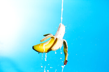 Banana with Milk pouring - obrazy, fototapety, plakaty