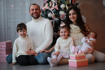 A young family with children decorates the house for the holiday. New Years Eve. Waiting for the new year.