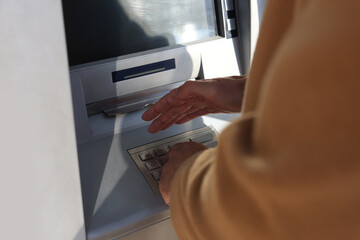 Man using modern cash machine, closeup of hand