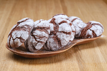 Brown chocolate chips cookies on a wooden plate