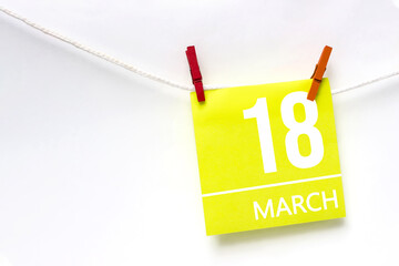 March 18th. Day 18 of month, Calendar date. Paper cards with calendar day hanging rope with...