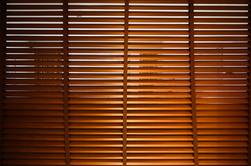 open wooden venetian blinds. lighting range control sunlight coming from a window. decoration interior. Modern jalousie.