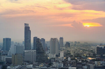Fototapeta na wymiar Cityscape of modern buildings and urban architecture. Aerial view of Bangkok city at twilight sunset in Thailand.