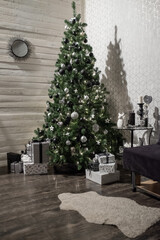 Stylish living New Year's Interior with Christmas Tree with Gifts decor garland December. New Year. Merry Christmas and happy holidays.