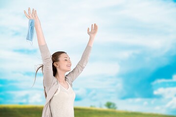 Woman with raising hands on the nature background