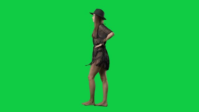 Super slow motion of bikini fashion model woman walking side view. Full body isolated on green screen background