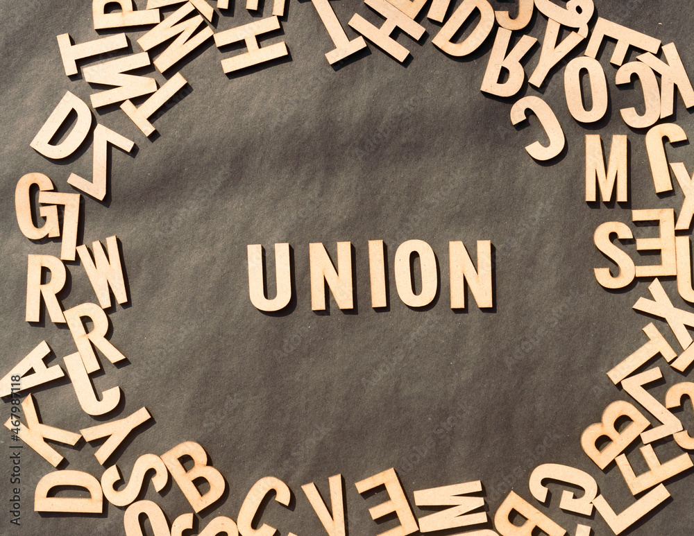 Fototapete union word in wooden cube alphabet letters top view on a rustic paper background.