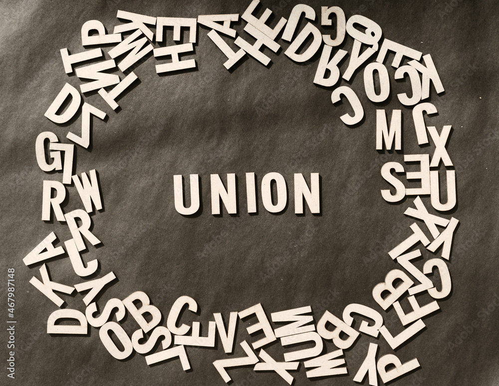 Fototapete union word in wooden cube alphabet letters top view on a rustic paper background.
