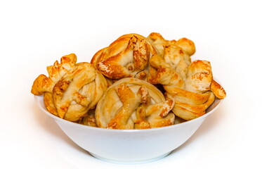 Homemade bread rolls with sugar in a white ceramic plate on a white background