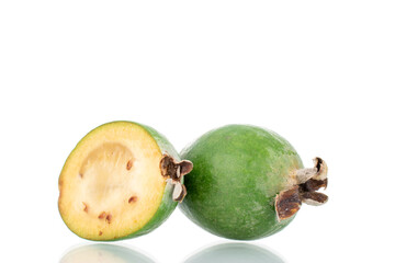 One whole and one half organic sweet feijoa fruit, close-up, isolated on white.